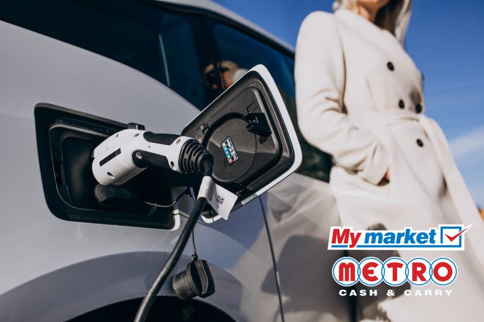 Woman charging electro car by her house