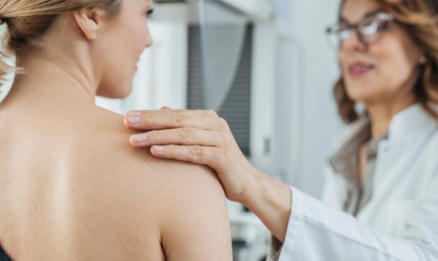 Pretty,Caucasian,Woman,Doctor,Talking,With,Her,Patient,On,Breast