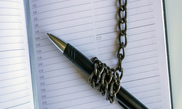 A,Pen,Wrapped,In,An,Iron,Chain,Lies,On,An