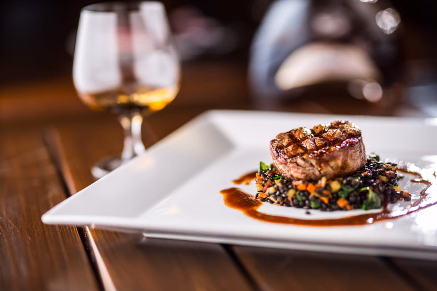 Beef-Steak-Grill-beef-steak-black-lentils-mixed-with-vegetable-Cognac-or-brandy-as-drink-Culinary-food-in-hotel-pub-or-restaurant-1536×1024